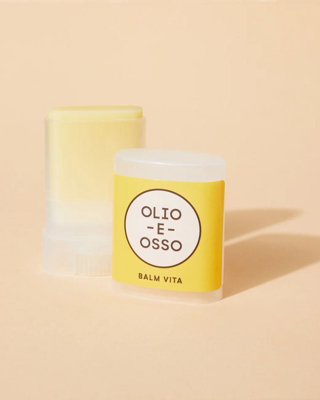 Two containers of Olio E Osso Balm Vita on a beige background