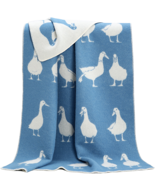 Blue blanket with white duck patterns on a white background