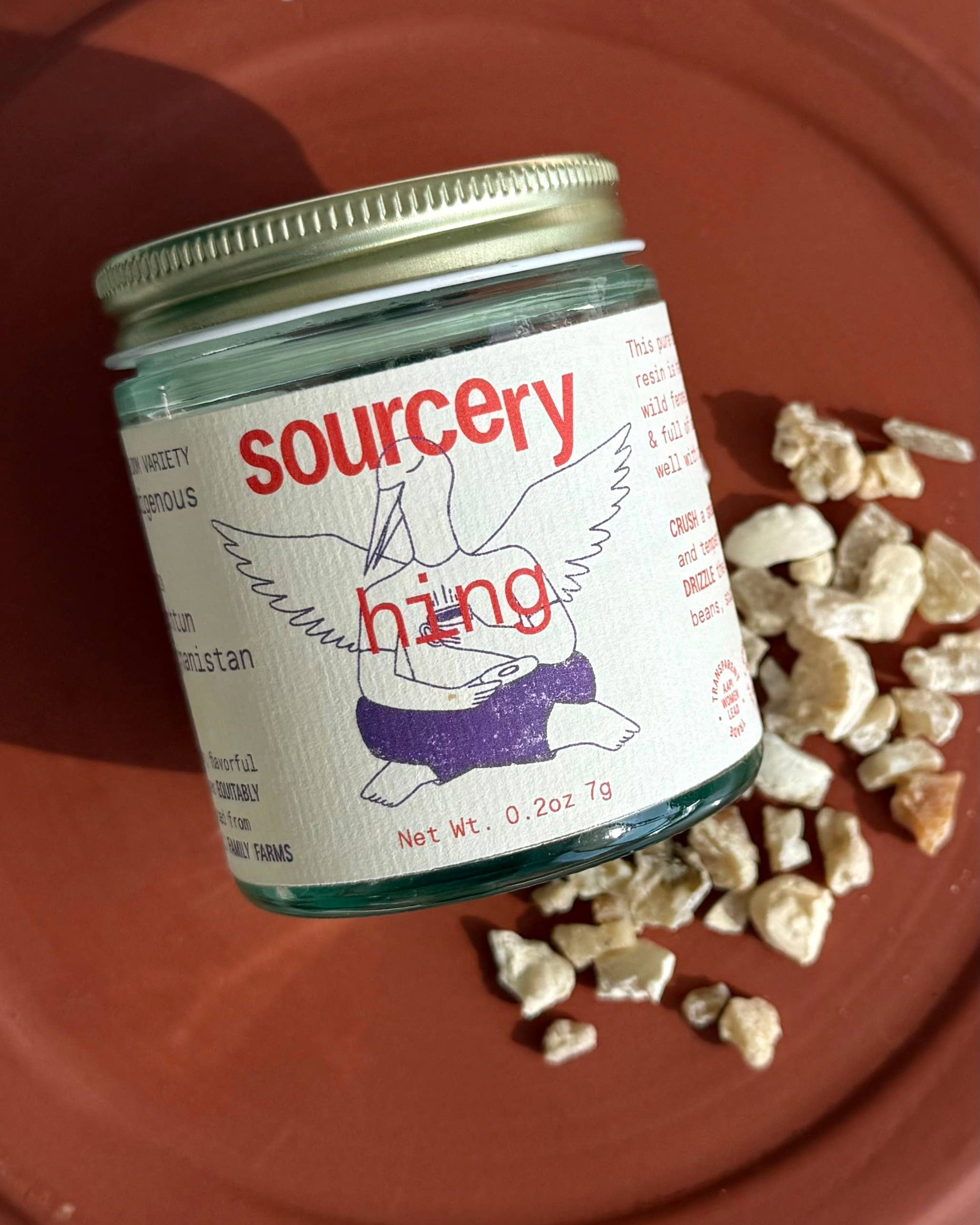 Jar of 'sourcery' with a label on a red background