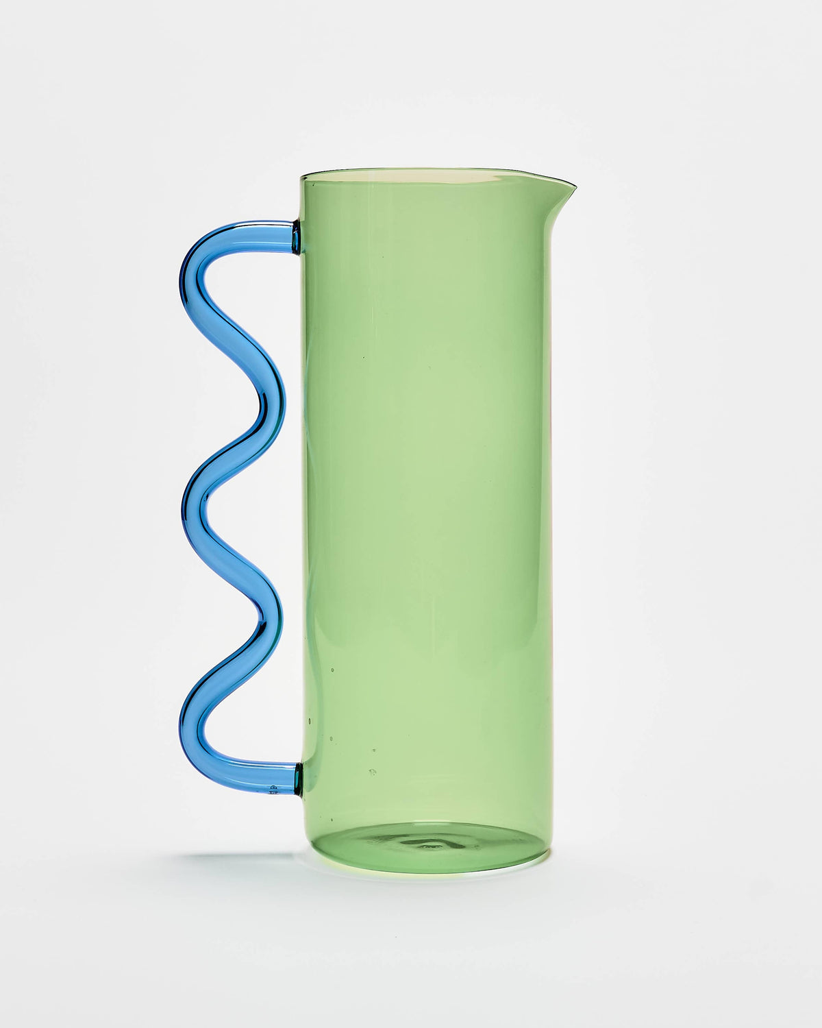 A translucent light green glass pitcher with a distinctive wavy blue handle, shown against a clean white background.