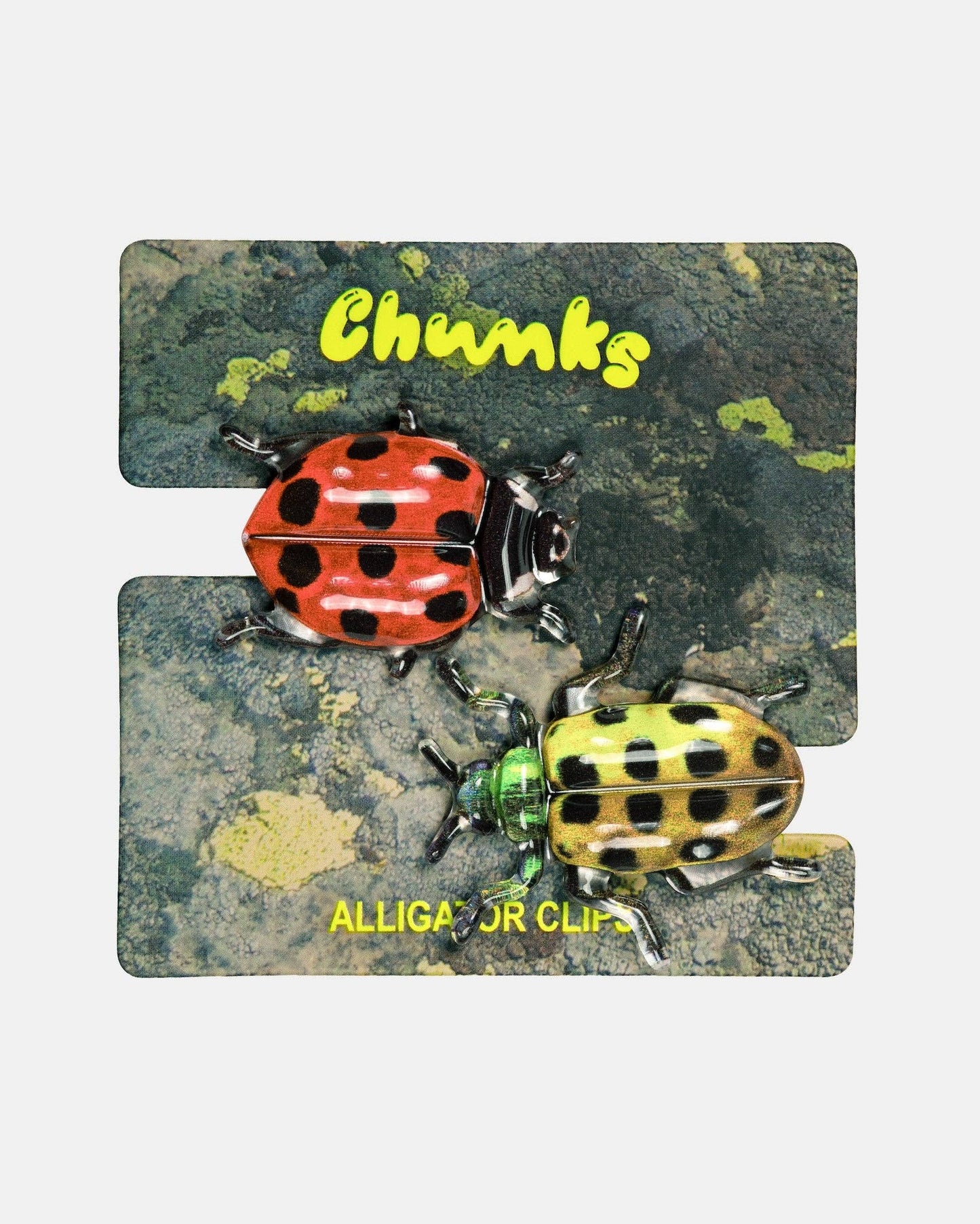 A set of two interlocking jigsaw puzzle pieces featuring a rustic, mossy background with two ladybugs and yellow text reading 'Chunks' and 'ALLIGA OR CLIP'.