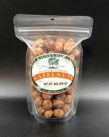 Packaged hazelnuts with a visible brand label on a black background