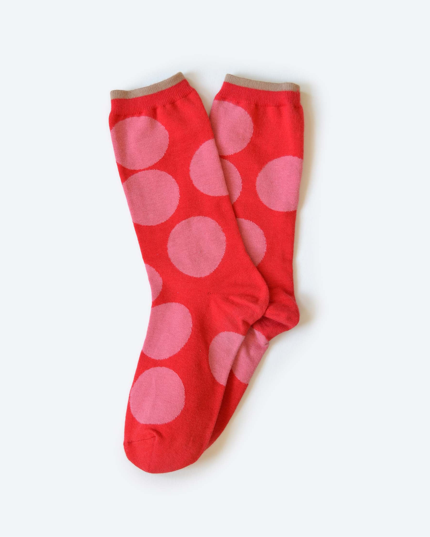 Red socks with pink polka dots on a white background
