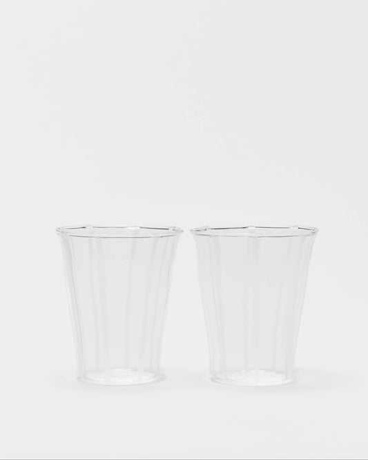 Two clear ribbed plastic cups on a plain white background.