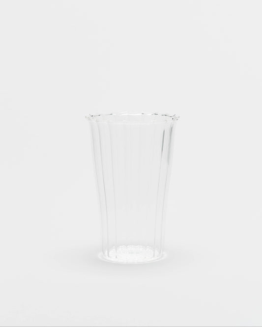 A clear ribbed plastic cup with a flared rim, shown on a seamless light gray background.