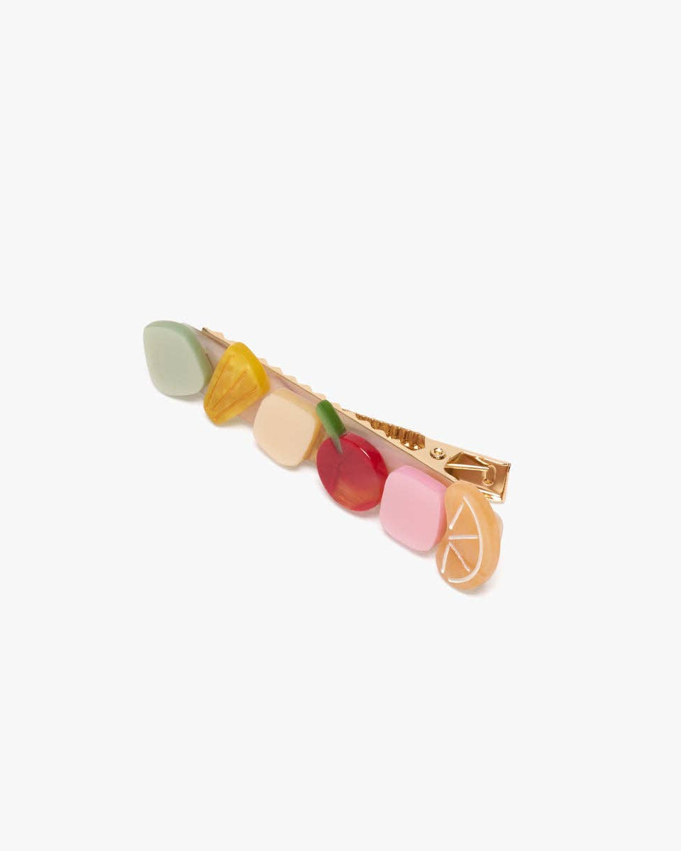 Colorful fruit-shaped barrette on a white background