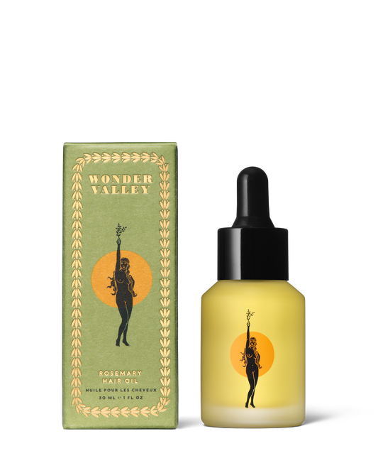 Bottle of Wonder Valley hair oil with packaging on a white background