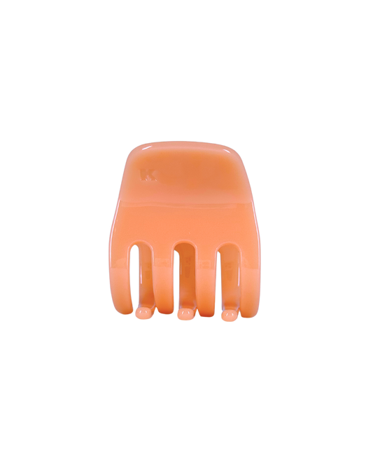 Orange hair comb on a white background