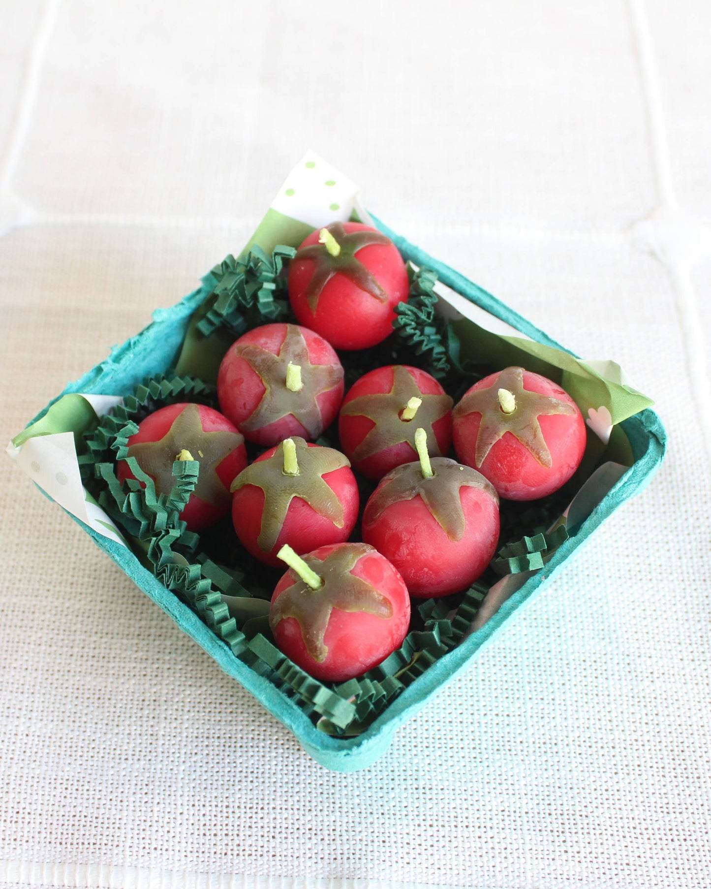 Decorative apples in a teal box on a white background
