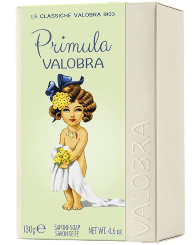 A boxed bar of soap labeled 'Primula Valobra' with a pale green front panel, cream-colored side panel, and an illustration of a young girl in a white dress holding yellow flowers. The brand name VALOBRA is embossed vertically on the side.