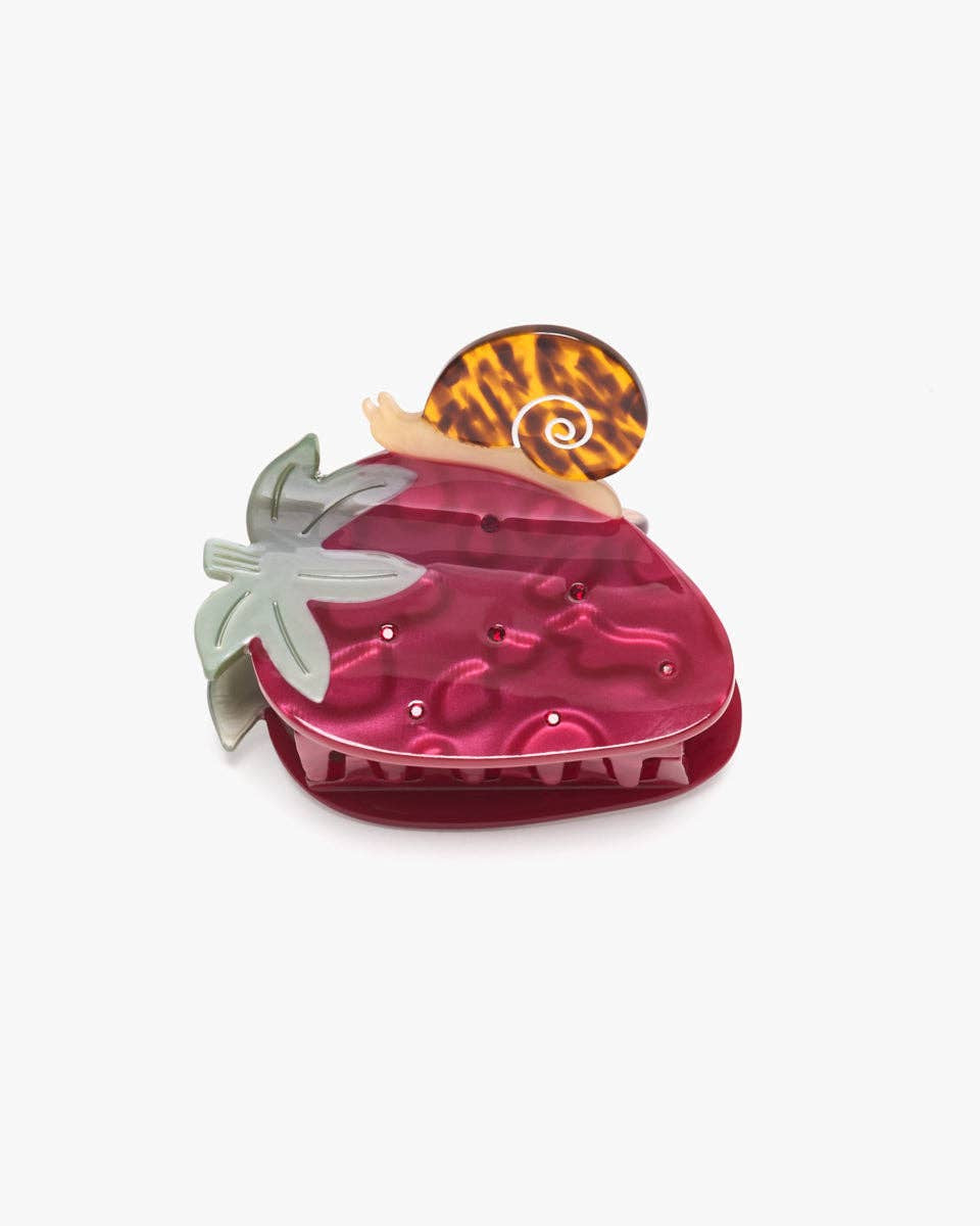 Pink strawberry-shaped container with a leopard print lid on a white background