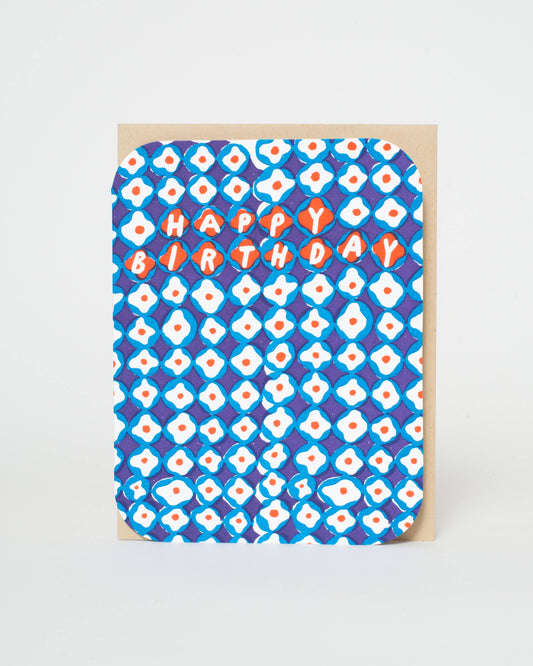 Greeting card with blue and white pattern and 'Happy Birthday' text on a beige background