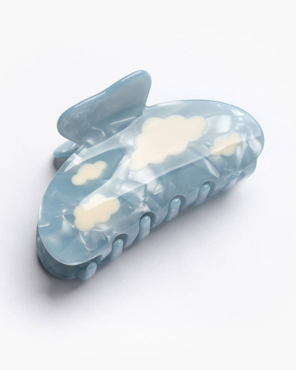 Blue hair clip with cloud designs on a white background