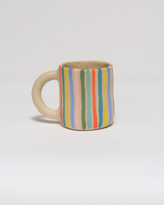 Ceramic mug with striped pattern on a light gray background