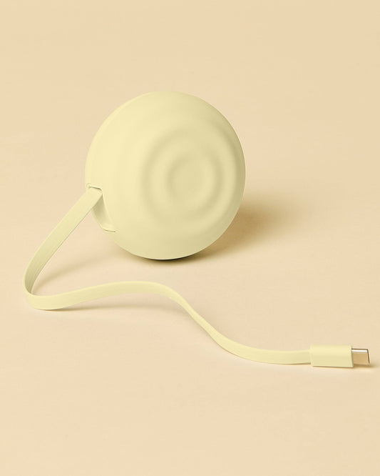 Light green retractable cable on a beige background