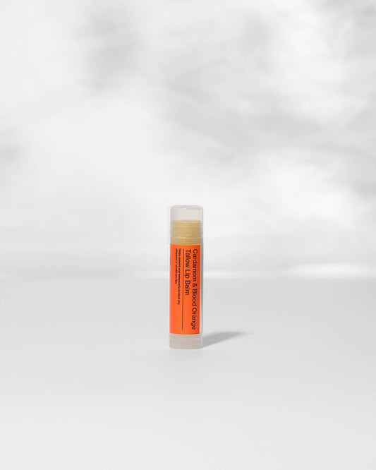 Lip balm tube with orange label on a white background