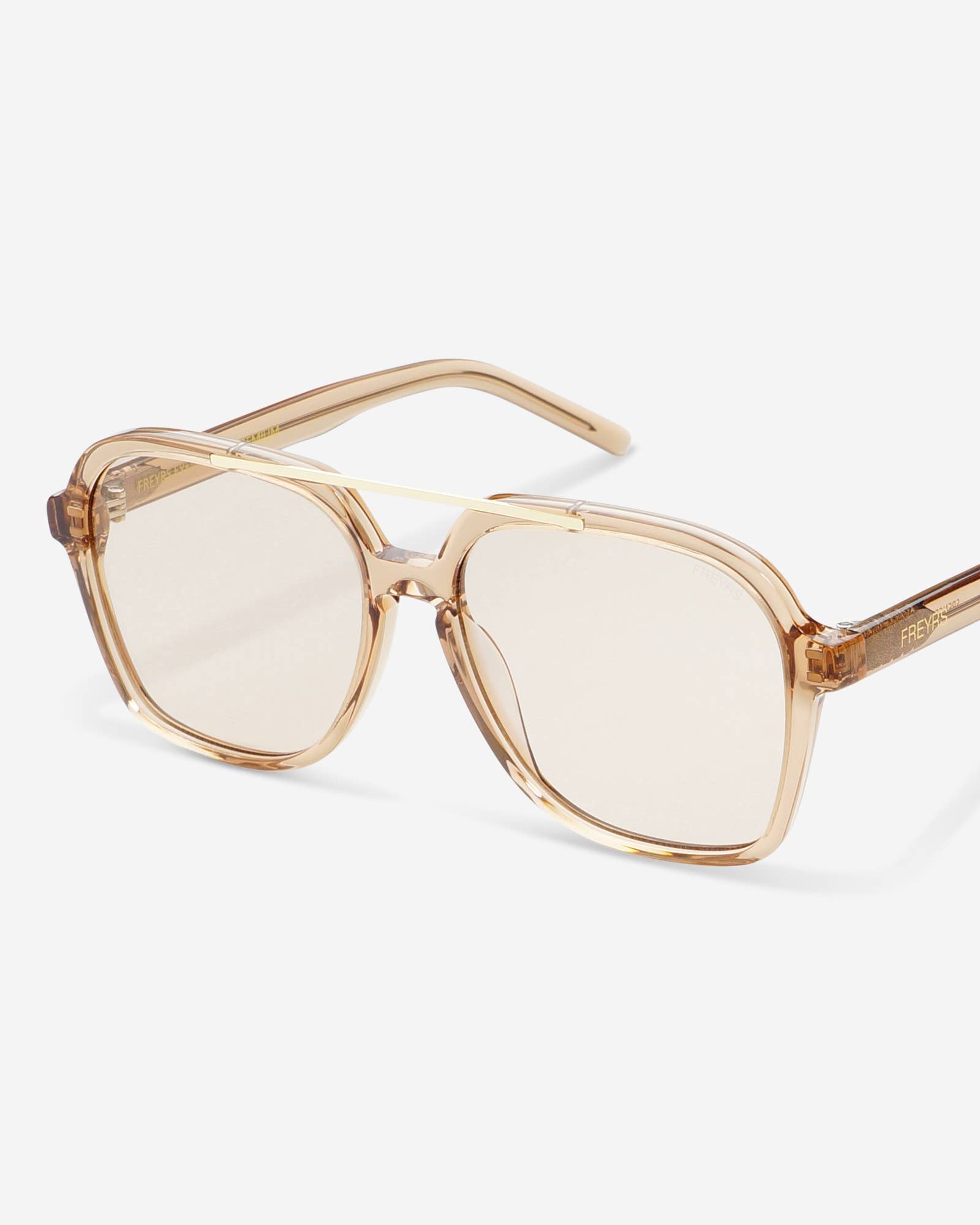 A pair of oversized square sunglasses with a translucent warm beige frame and light pink-tinted lenses, shown on a clean light gray background.