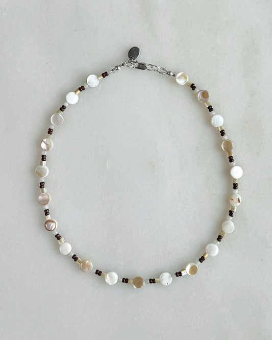 Necklace with beads on a light gray background