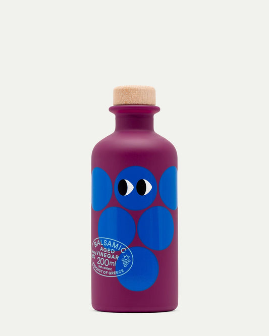 Purple bottle with blue abstract design and cork cap on a white background