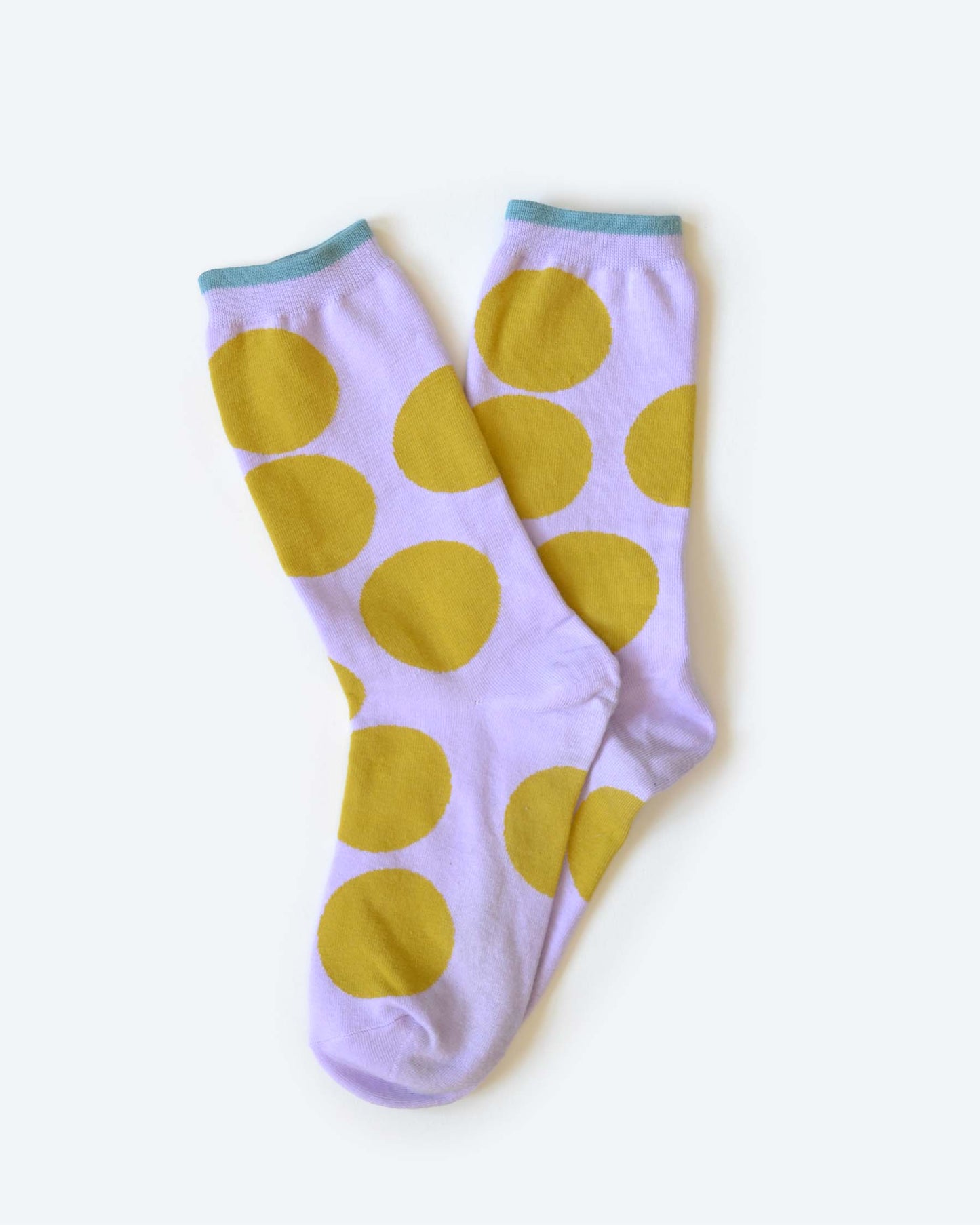 Pair of socks with yellow polka dots on a light purple background