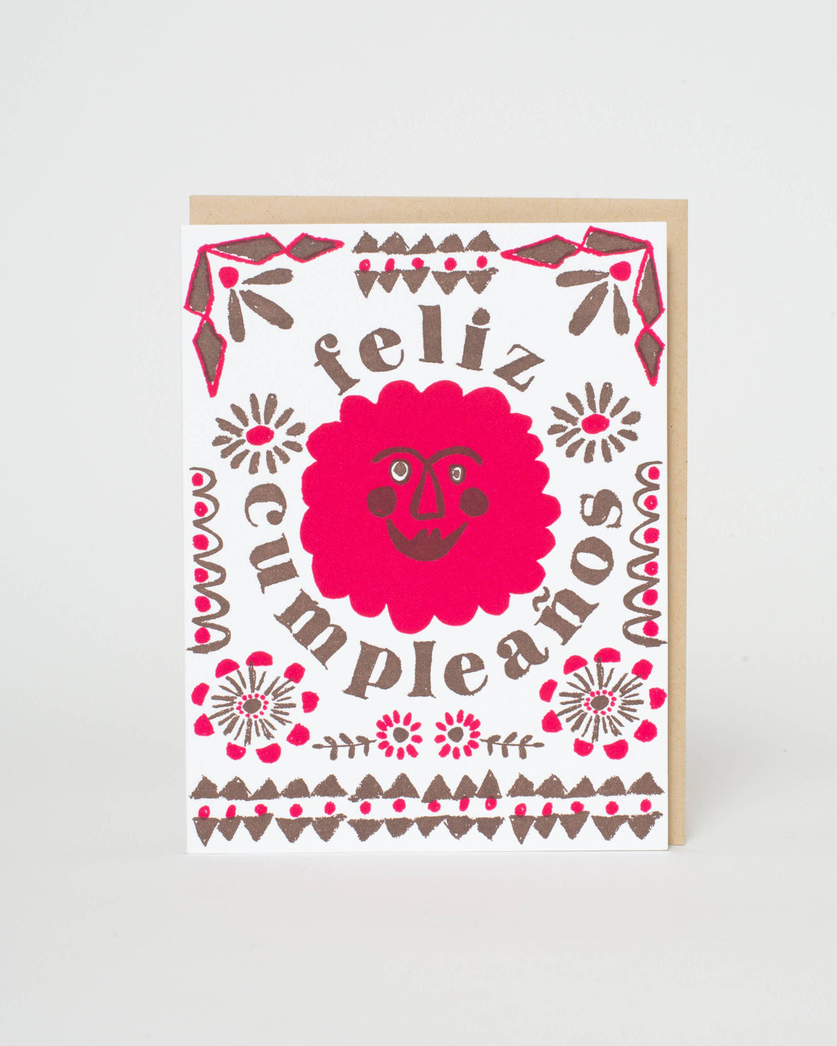 Greeting card with 'feliz cumpleaños' text and decorative elements on a white background