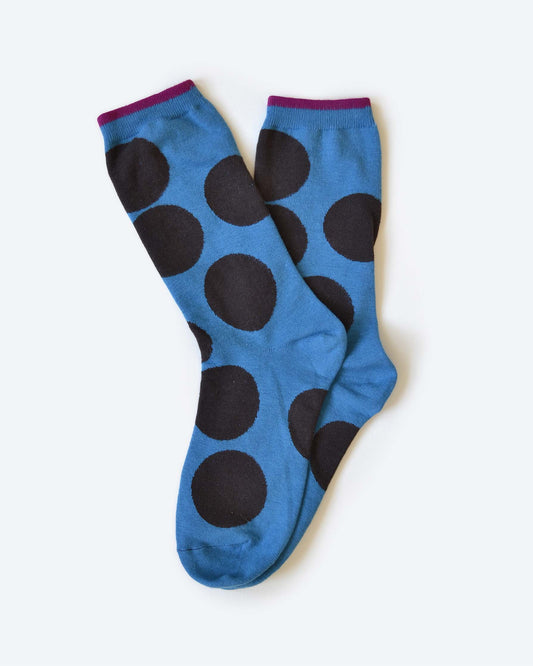 Blue socks with black polka dots on a white background
