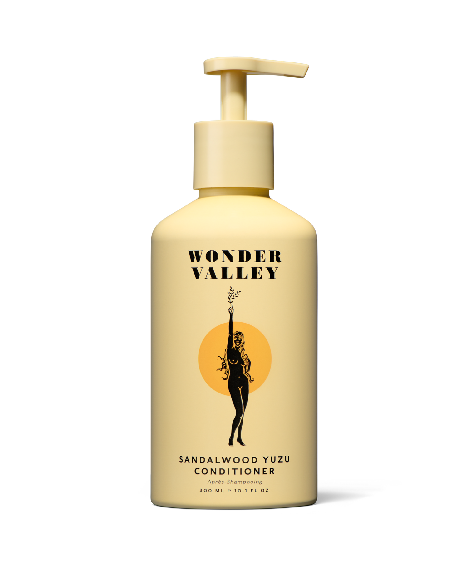 Yellow conditioner bottle with pump labeled 'Wonder Valley' on a white background