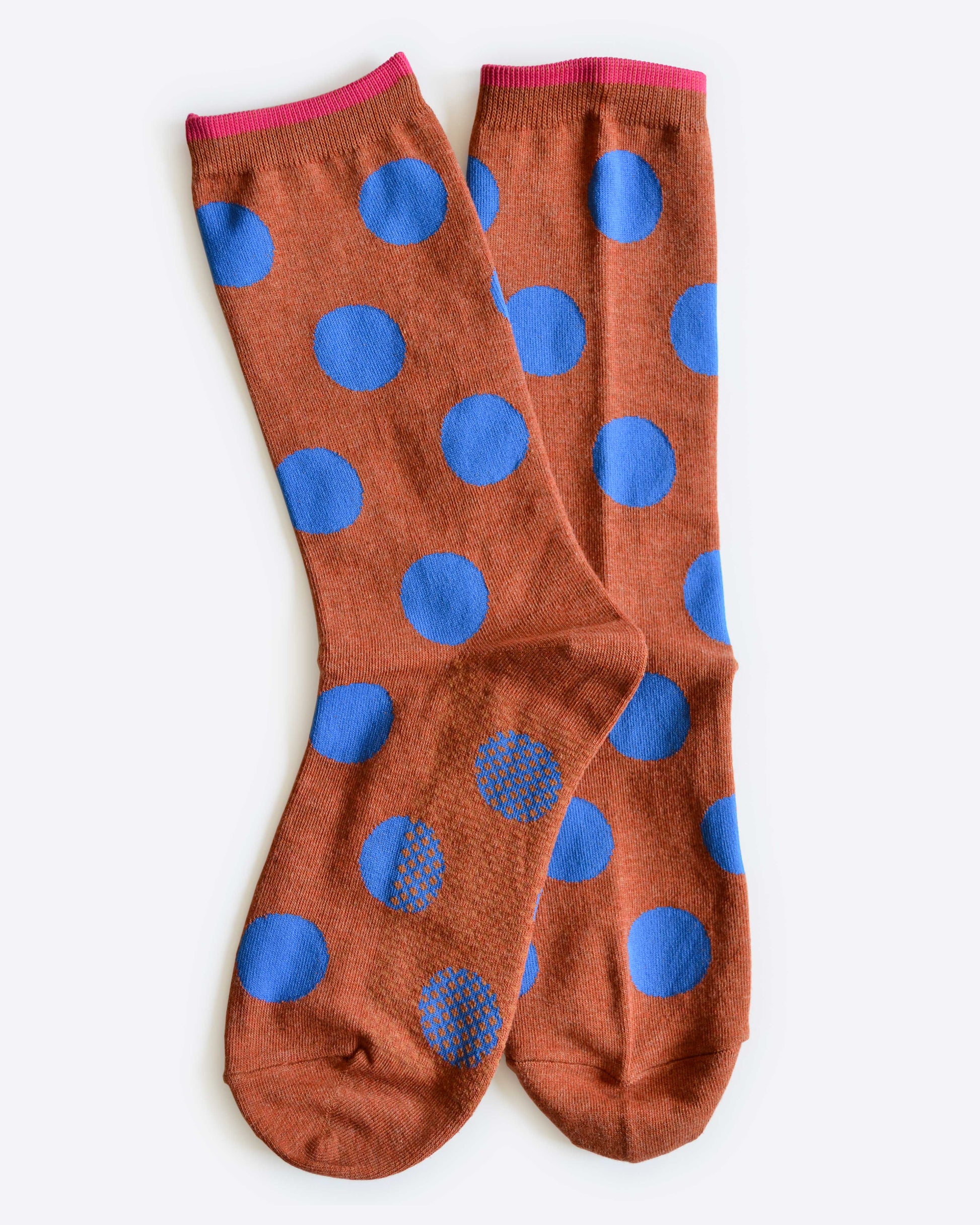 Brown socks with blue polka dots on a white background