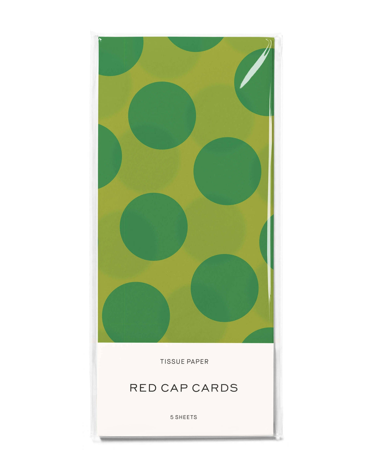 Tissue paper packaging with green polka dot design on a white background