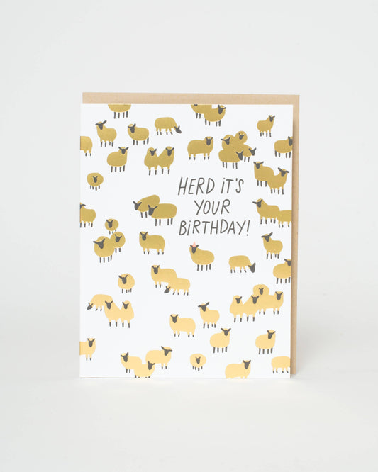 Greeting card with sheep pattern and 'Herd it's your birthday!' text on a white background
