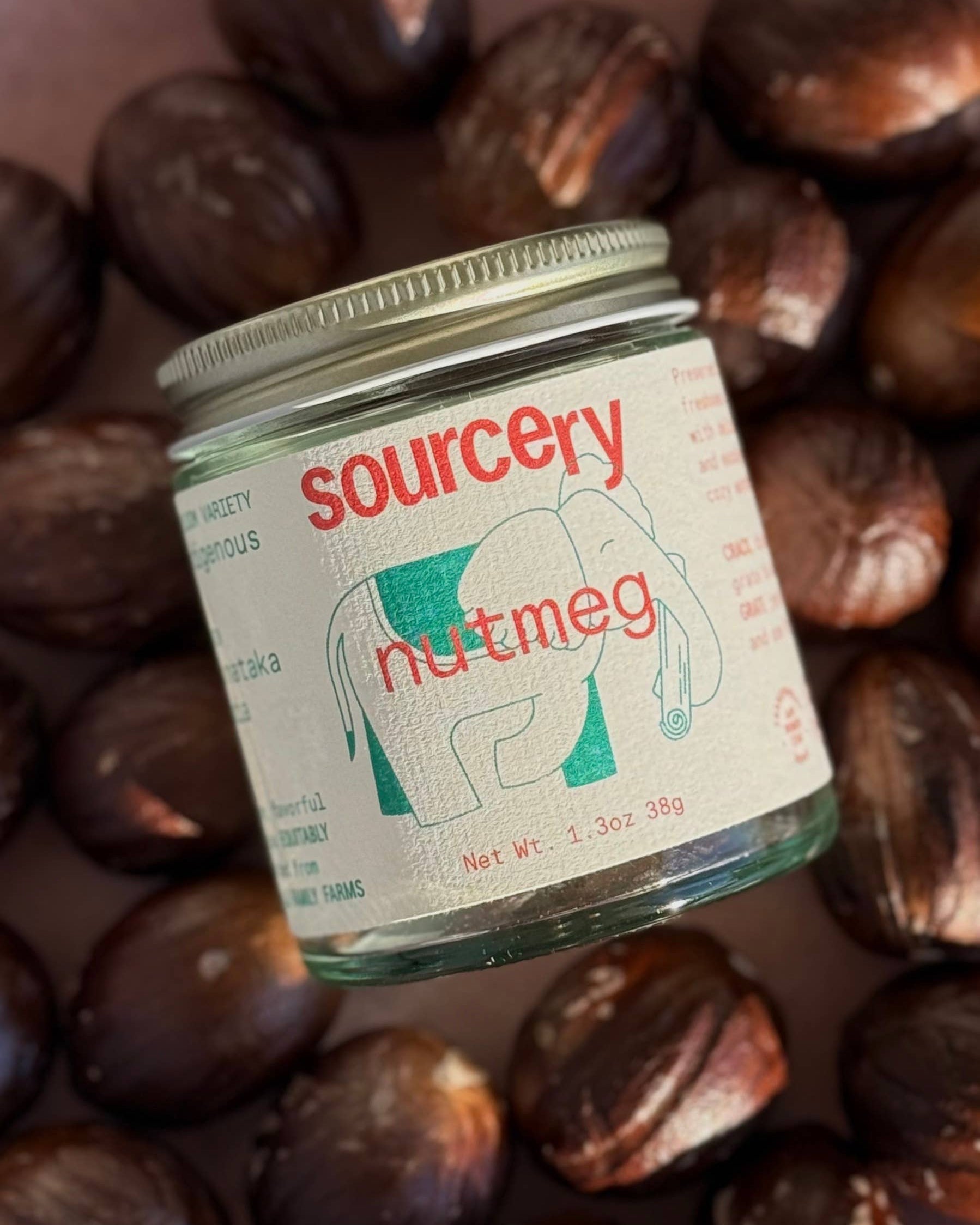 Jar of 'sourcery' nutmeg surrounded by chestnuts