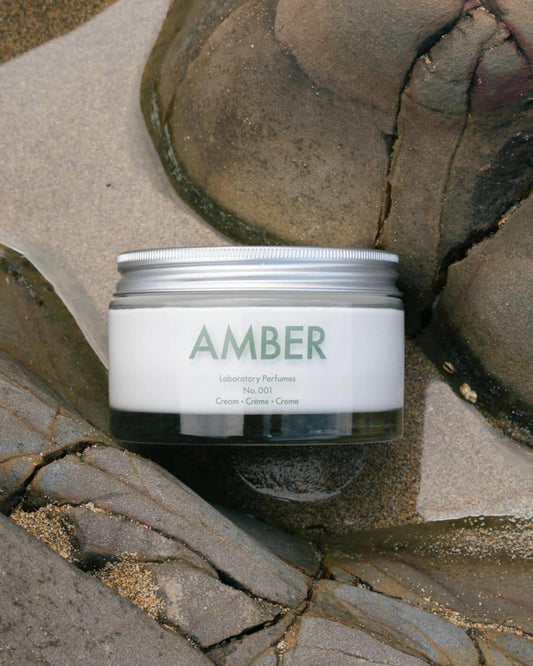 Jar of 'AMBER' cream on a rocky surface