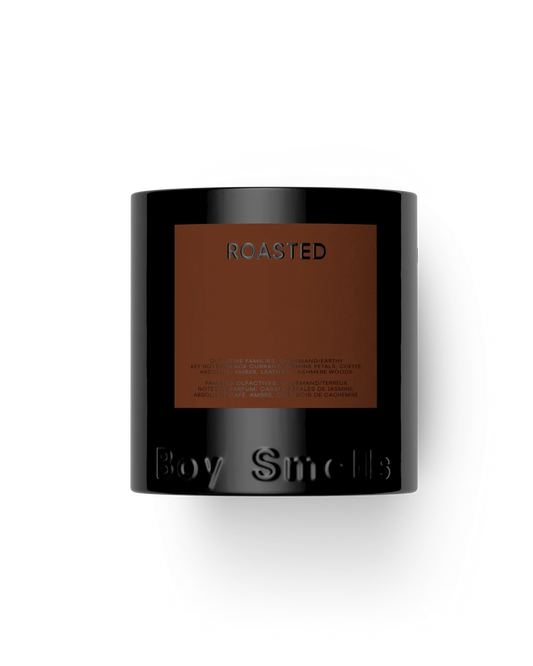 Black candle with 'Roasted' label on a white background
