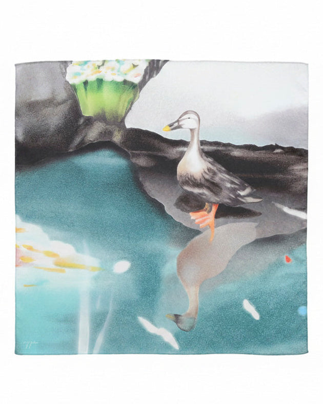 A square scarf featuring a watercolor-style illustration of a duck standing in reflective blue water, with dark rocks and a pale sky in the background.