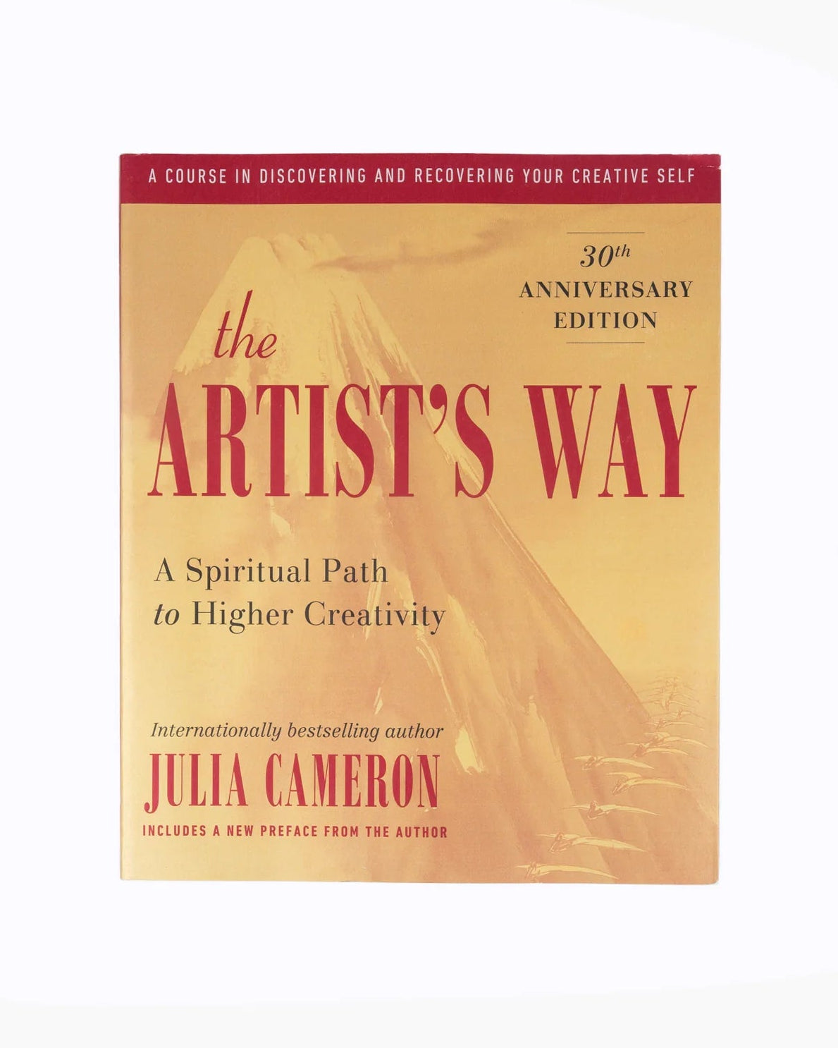 The Artist's Way 30th Anniversary Edition book by Julia Cameron, featuring a warm beige cover with red and black text, shown against a plain white background.