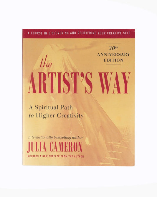 The Artist's Way 30th Anniversary Edition book by Julia Cameron, featuring a warm beige cover with red and black text, shown against a plain white background.