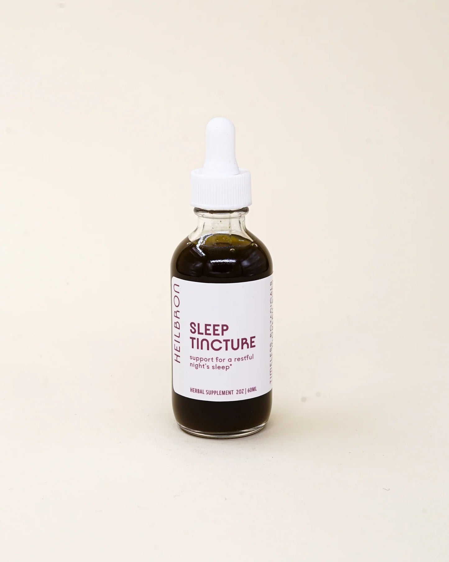 Sleep tincture bottle with dropper on a beige background