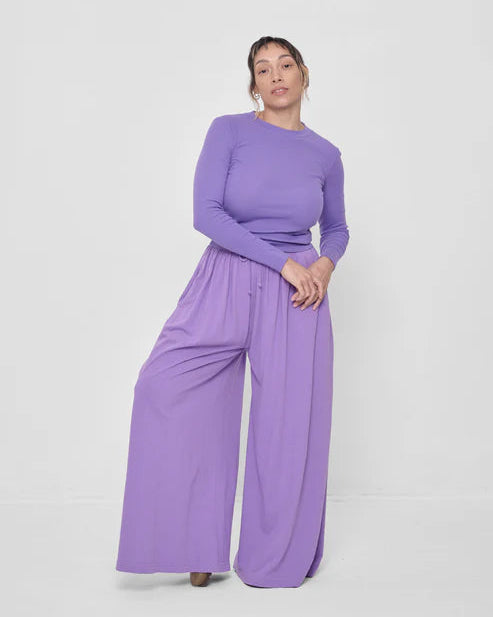 Woman wearing a purple outfit on a white background