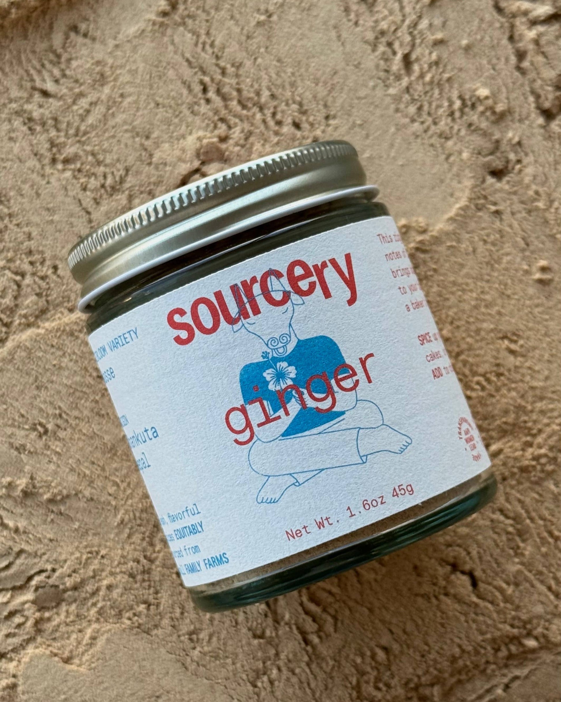 Jar of sourcery ginger on a textured beige surface