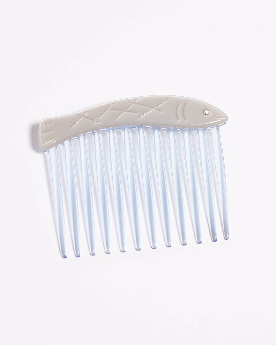 Clear plastic comb with beige plastic handle on a white background