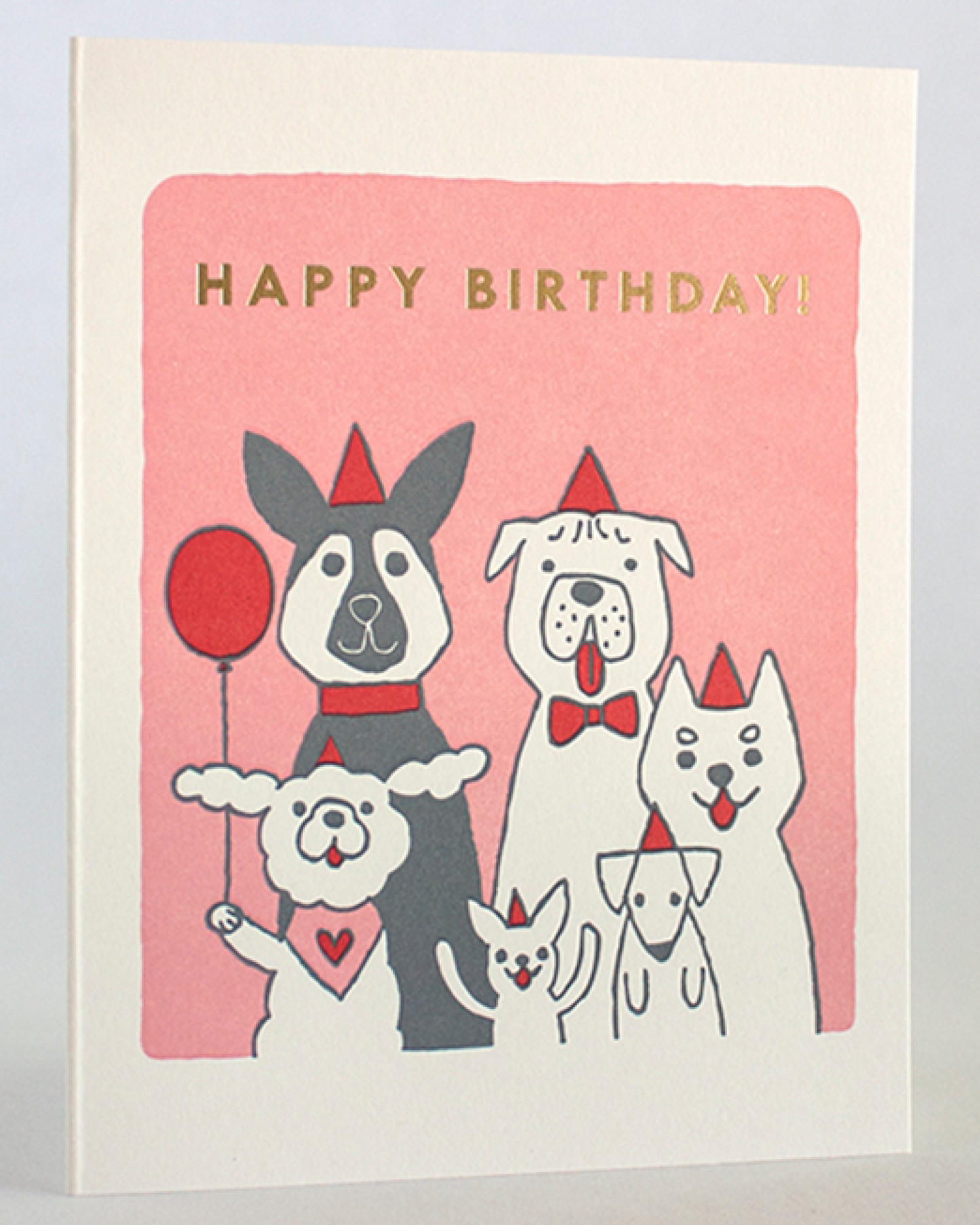 Birthday card with cartoon dogs and 'Happy Birthday!' text on a pink background