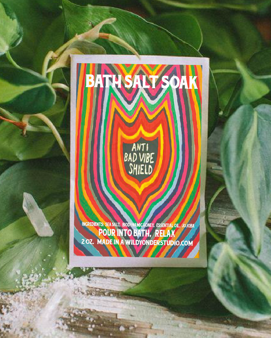 Bath salt soak packaging with colorful design and text on a leafy background
