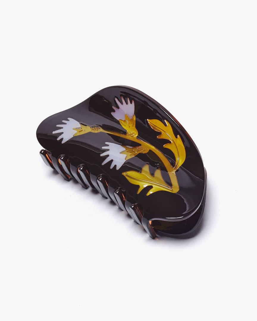 Decorative hair comb with floral design on a white background