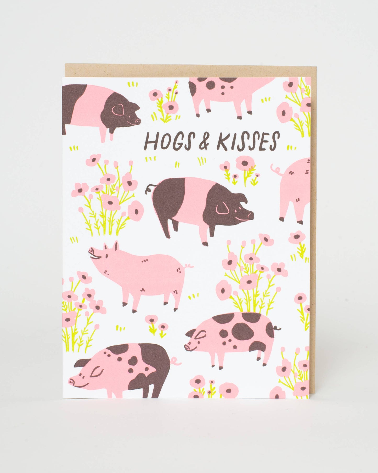 Greeting card with pink and brown pigs and flowers on a white background