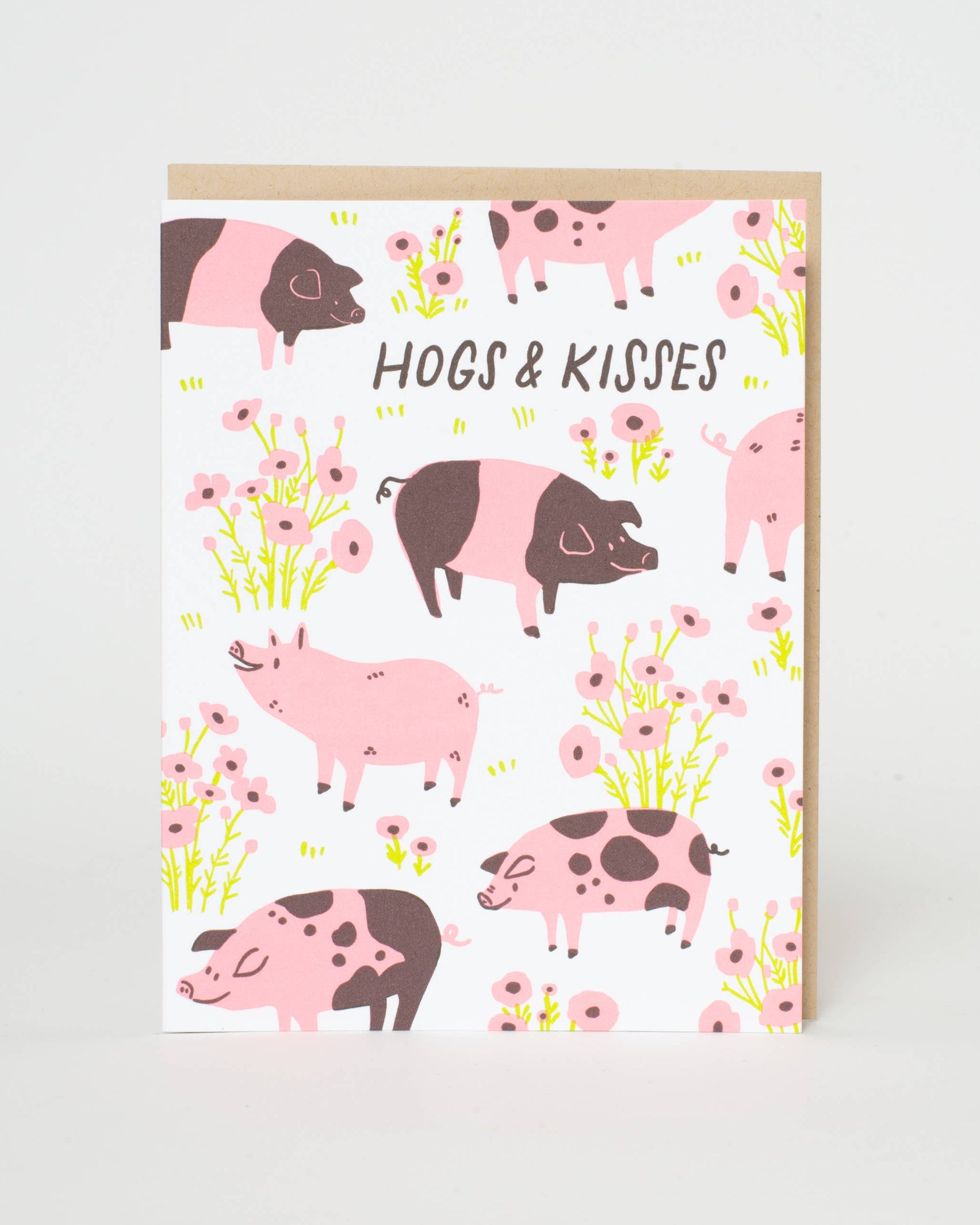 Greeting card with pink and brown pigs and flowers on a white background