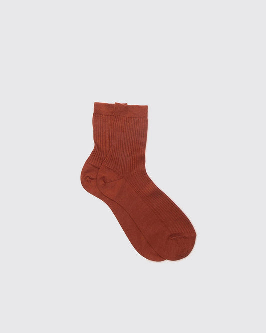 Brown sock on a light gray background