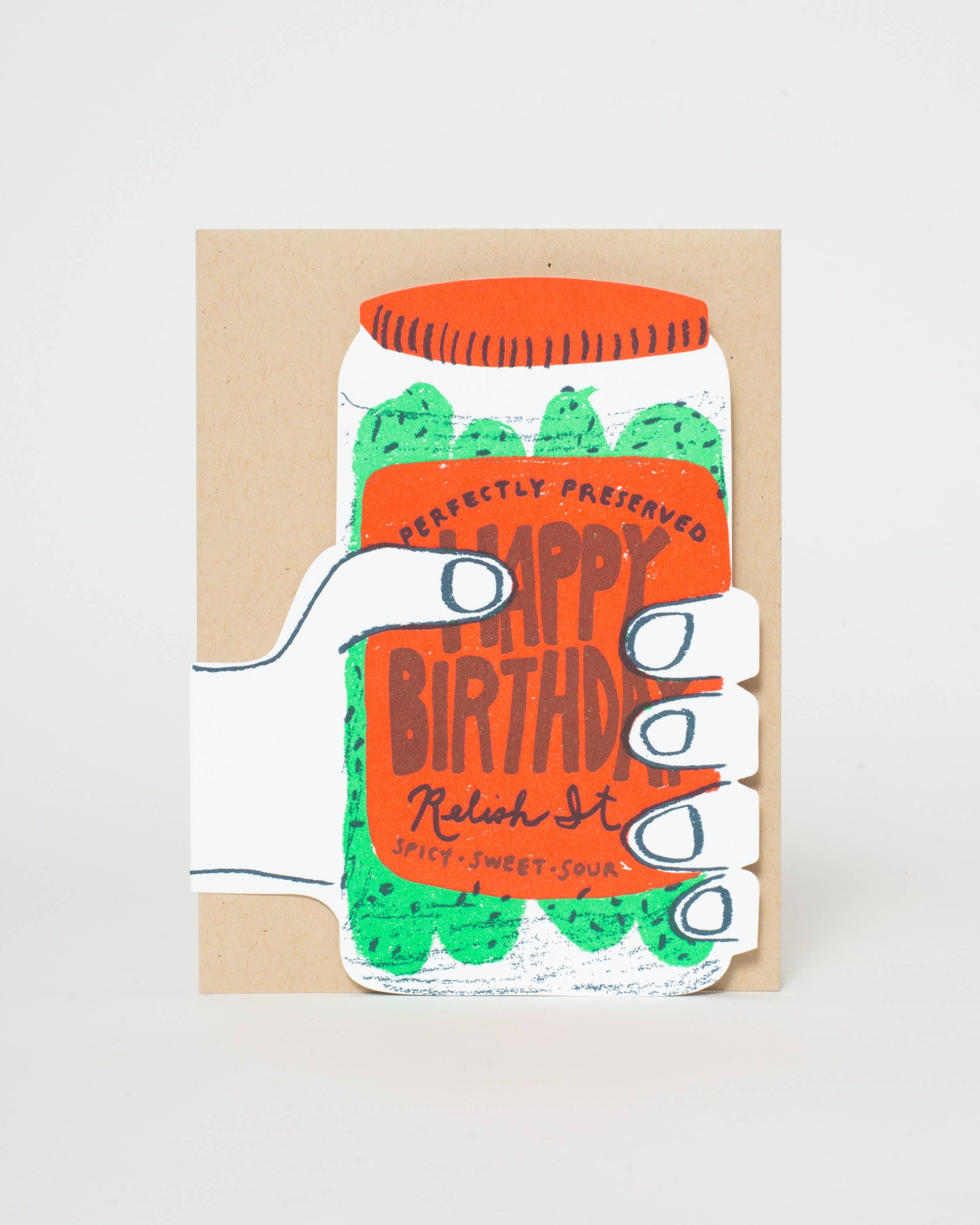 Greeting card with a design of a hand holding a jar labeled 'Happy Birthday' on a beige background.