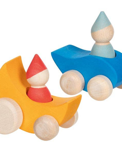 Two wooden toy figures in colorful cars on a white background