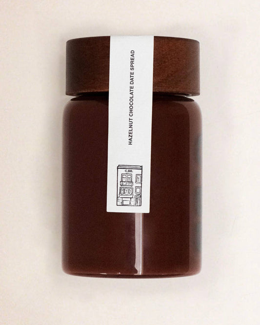 Jar of chocolate spread with a label on a beige background