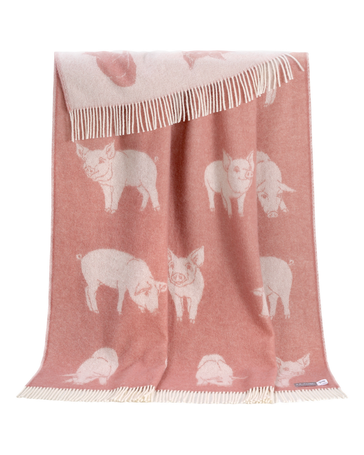 Pink blanket with white pig designs on a white background